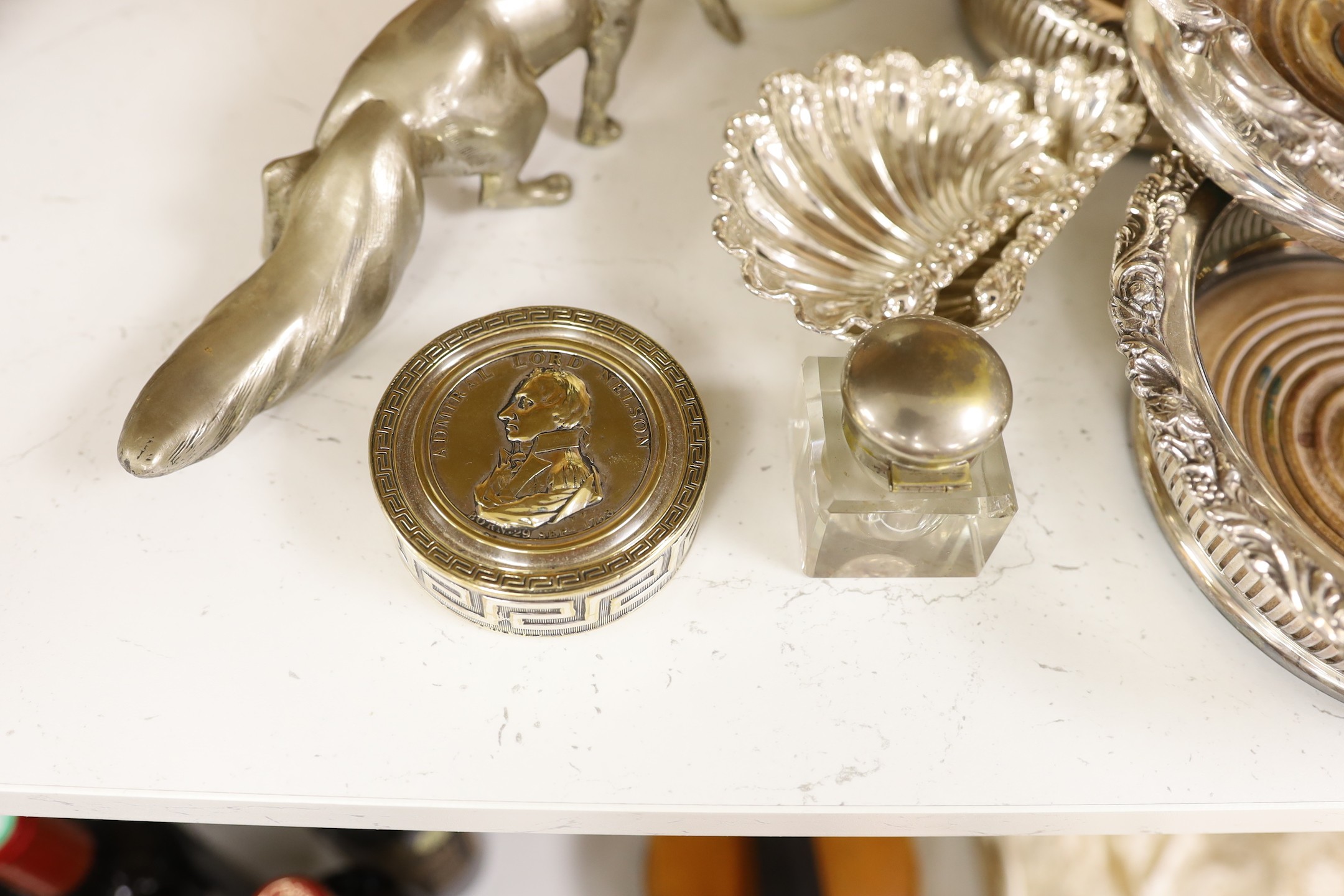Three silver plated wine coasters, a pair of shell butter dishes, fox, ink well and a cocktail shaker